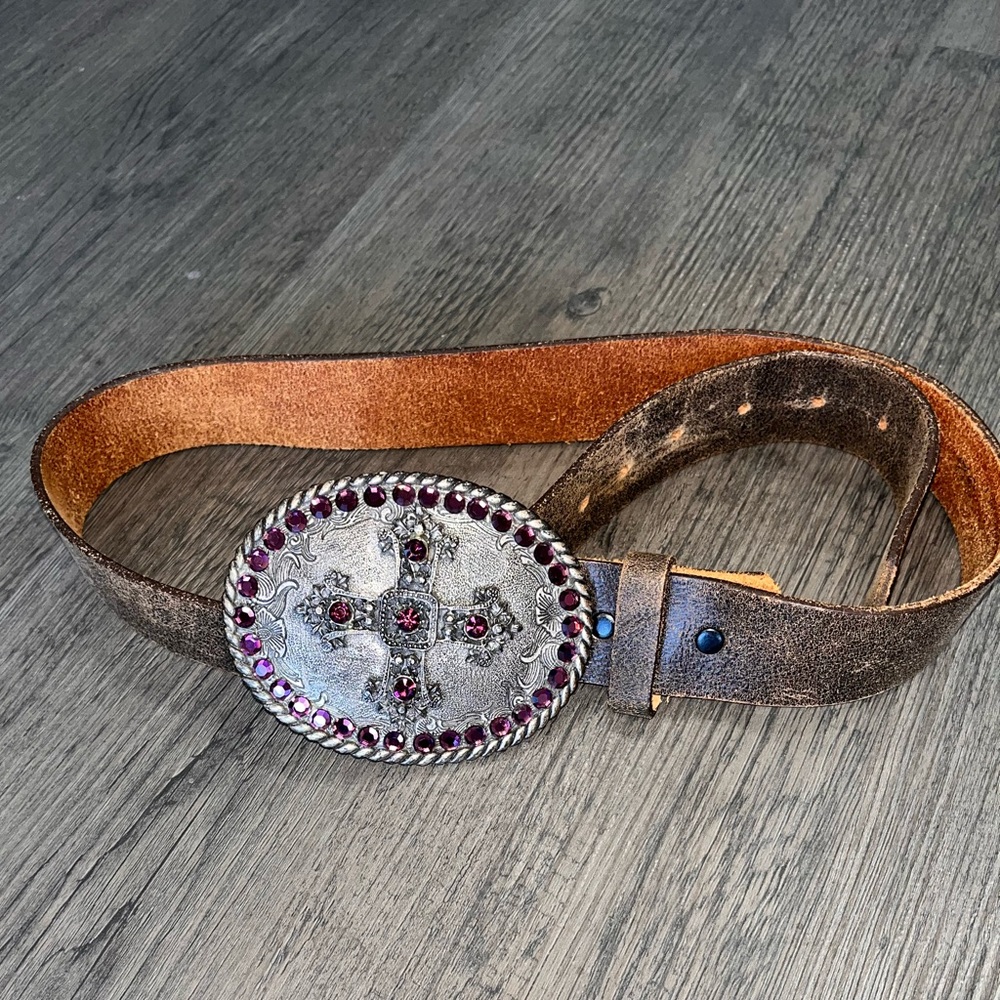 Distressed leather belt with gem buckle.